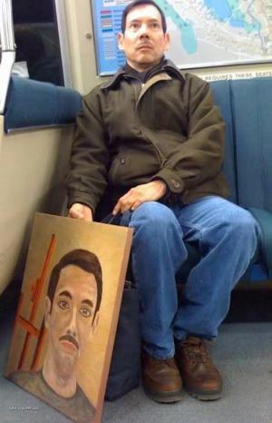 Man Poses for Picture of Himself with a Picture of Himself